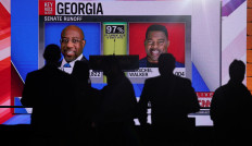 Supporters of Reverend Raphael Warnock, Democratic Senator for Georgia attend a election night party after polls closed for the US midterm runoff elections between Warnock and his Republican challenger Herschel Walker in Atlanta, Georgia, US, December 6, 2022. 