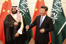  In this file photo Saudi Arabia's then-deputy Crown Prince Muhammad bin Salman (left) looks on as Chinese President Xi Jinping (right) gestures to greet arriving members of the Saudi delegation during a meeting at the Diaoyutai State Guesthouse in Beijing on August 31, 2016. 