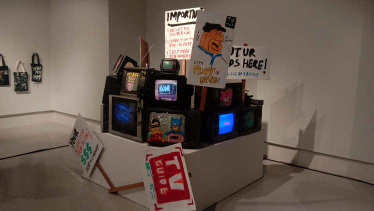 3D art: Stacks of old televisions, with several written signs, are presented near the entrance of Naufal Abshar's exhibition at ASHTA District 8 Jakarta. (JP-Radhiyya Indra)