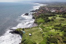 In this aerial picture taken on September 1, 2022, shows the 7th hole of the defunction the Trump International golf club and residence, which has been transformed into Pitu Sunset Spots, a beach cafe in Tanah Lot temple tourist destination in Tabanan, since the former US president Donald Trump, was unable to complete the real estate development in 2017. 
