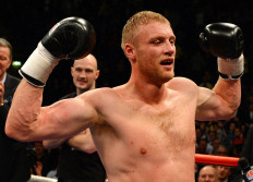 Former England cricketer turned professional boxer Andrew Flintoff celebrates his victory over US boxer Richard Dawson in their heavyweight boxing bout at the Manchester Arena in Manchester, north-west England on November 30, 2012. Flintoff won the fight on points to score a victory in his first professional bout. 
