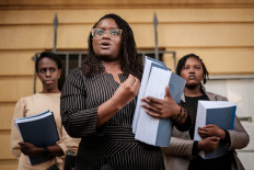 Kenyan lawyer Mercy Mutemi (C) speaks to the media after filing a lawsuit against Meta accusing Facebook's parent company of fanning violence and hate speech in Africa at Milimani Law Courts in Nairobi on December 14, 2022.