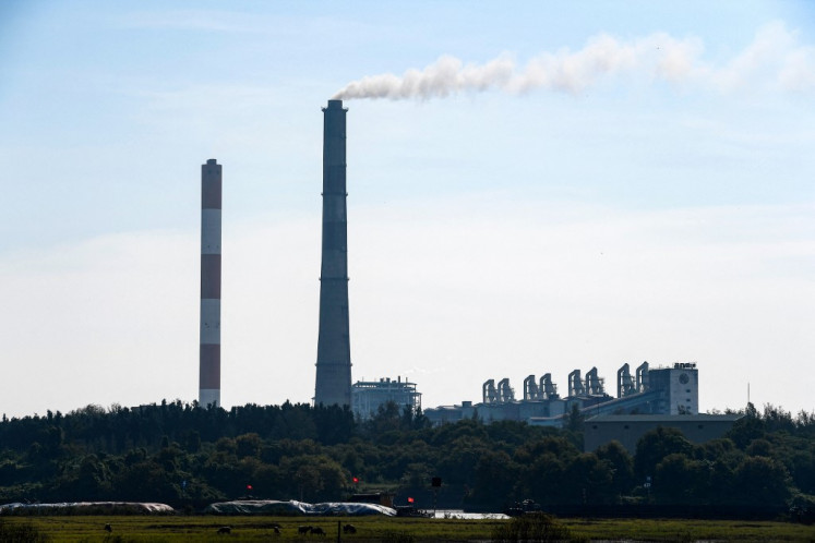 This photo taken on October 14, 2022 shows vessels carrying coal near Pha Lai thermal power plant in Hai Duong province, Vietnam. Solar power has boomed in Vietnam, its climate targets are ambitious, but the fast-growing economy is struggling to quit dirty energy -- leaving one of the biggest coal power development programs in the world largely intact.