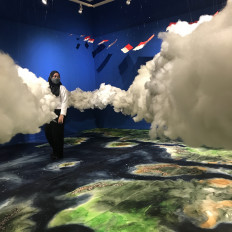 Amid the clouds: A visitor simulates flying by getting in the middle of Agus Budianto’s watercolor-installation "Melayang". (JP/Tunggul Wirajuda)