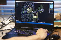 Tarn Adams, who cofounded Bay 12 Games with his brother Zach, demonstrates an old version of their single-player simulation game “Dwarf Fortress“ during an interview at their home office Poulsbo, Washington, west of Seattle, on December 9 2022. A cult favorite among indie game fans, “Dwarf Fortress“ has been available for purchase on the Steam online store since December 6, a first for this title that has been distributed for free since its debut in 2006. The real-time management game, set in a medieval-fantasy world and involving overseeing a group of dwarves seeking to build a mighty fortress, has climbed to the fourth best-selling weekly title on Steam.
