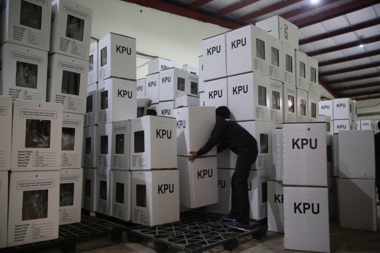 Workers from the Depok General Elections Commission (KPU) stack ballot boxes on November 25, 2020 at a warehouse in Cimanggis district, Depok, West Java. 