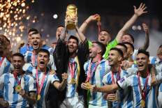 Argentina's forward #10 Lionel Messi lifts the World Cup trophy during the Qatar 2022 World Cup trophy ceremony after the football final match between Argentina and France at Lusail Stadium in Lusail, north of Doha on December 18, 2022. Argentina won in the penalty shoot-out.