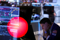 A trader works on the trading floor at the New York Stock Exchange (NYSE) in New York City, U.S., December 14, 2022. 