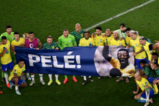 Soccer love: Brazil's players hold a banner dedicated to Brazilian football legend Pele at the end of the 2022 FIFA World Cup Qatar round of 16 football match between Brazil and South Korea at Stadium 974 in Doha on Dec. 5. 