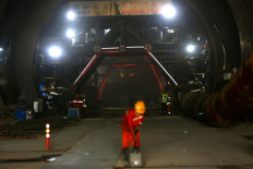 Workers arrange equipment inside a large tunnel built for a high-speed railway in Walini, West Bandung regency, West Java, on February 21, 2019.