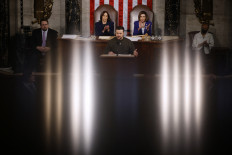 U.S. Vice President Kamala Harris (lef) and Speaker of the House Nancy Pelosi listen to President of Ukraine Volodymyr Zelensky addresses a joint meeting of Congress in the House Chamber of the US Capitol on Dec. 21, 2022 in Washington, DC.