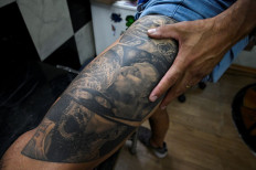 Eternal ink: Diego Quiros, 44, shows his tattoo of Argentine soccer star Lionel Messi kissing the Copa America trophy, on Tuesday in Buenos Aires.