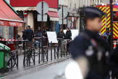 French police secure the street after several shots were fired along rue d'Enghien in the 10th arrondissement, in Paris on Dec. 23, 2022. 