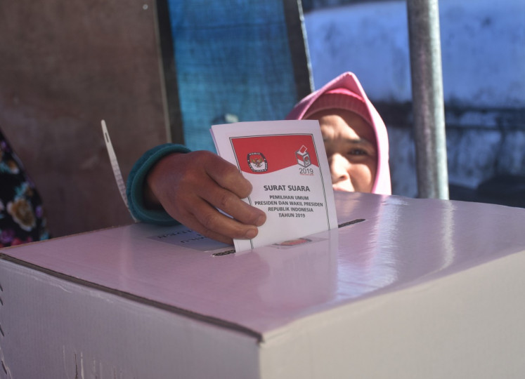 A Tengger tribe resident casts her ballots at polling station 03 in Ranupani village, Lumajang, East Java in April 2019. 