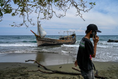 This picture shows a boat that was carrying Rohingya refugees after their arrival at a beach in Krueng Raya, Aceh province on December 25, 2022. 
