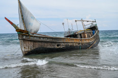 This picture shows a boat that was carrying Rohingya refugees after their arrival at a beach in Krueng Raya, Aceh province on December 25, 2022. 
