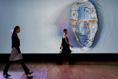 Models present first designer-led AI fashion collections which was assisted by AiDA, during “Fashion X AI : Call For Young Talents 2022“ fashion show in Hong Kong, China, December 19, 2022