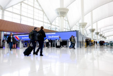 Travelers walk past the Southwest Airlines check-in counter at Denver International Airport on December 28, 2022 in Denver, Colorado. More than 15,000 flights have been canceled by airlines since winter weather began impacting air travel on December 22. 
