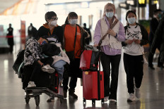 Passengers walk through a departure terminal of the international airport in Beijing on Dec. 29, 2022. 
