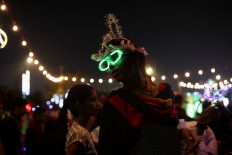 A girl sells glasses and headbands ahead of New Year's celebrations at a promenade in Mumbai, India, on Dec. 30, 2022.