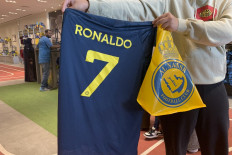 Soccer euphoria continues: A fan holds a t-shirt bearing the name Ronaldo and number 7, at the Saudi Al Nassr Football Club shop in the Saudi capital Riyadh, on Dec. 31, 2022.