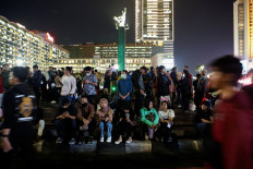 People are seen at the Bundaran Hotel Indonesia traffic circle, where the New Year's Eve is usually celebrated in Jakarta, on Dec. 31, 2022.