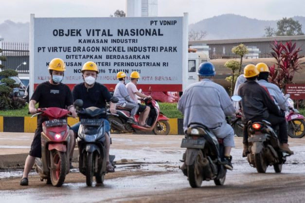 Nickel tussle: Employees ride motorcycles  on Sept. 21, 2022, outside the Virtue Dragon Nickel Industry nickel smelting facility in Konawe, Southeast Sulawesi. The government has banned exports of nickel ore to support its downstreaming policy.