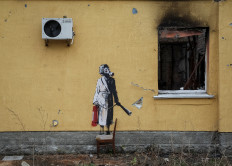 A new graffiti in Banksy's signature style, although not posted by the mercurial artist on social media, is seen on the wall of a destroyed building in the Ukrainian town of Hostomel, which had been occupied by Russia until April and heavily damaged by fighting in the early days of Russian invasion, November 13, 2022.