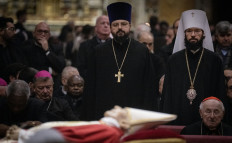 Metropolitan Anthony of Volokolamsk (right) pays his respect to Pope Emeritus Benedict XVI lying in state at St. Peter's Basilica in the Vatican, on Jan. 4, 2023. 