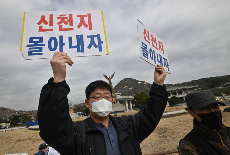 Parents hold placards reading “Let's drive out Shincheonji“ during a rally condemning the Shincheonji Church of Jesus as their children run away from home to join the group, outside the presidential Blue House in Seoul on March 12, 2020.