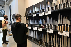 Knives out: Customers visit the Kama-Asa cutlery shop at Tokyo's famous Kappabashi kitchenware street on Nov. 24, 2022. 