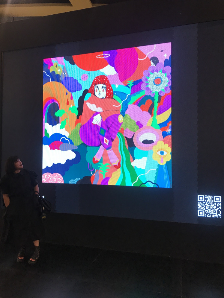 A look back: Diela Maharanie glances at her NFT “Days Like This“ at the opening of the Art Moments Jakarta exhibition on Nov. 4, 2022. (JP/Tunggul Wirajuda)