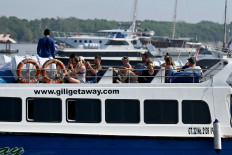 Foreign tourists are seen on Dec. 31, 2022 aboard a fast boat at a pier on Serangan Island, Bali.
