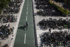 A man rides his bicycle past parked bicycles in Sheung Shui in Hong Kong, China, on Jan. 6, 2023.