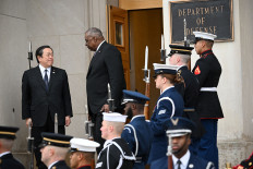 US Defense Secretary Lloyd Austin (center) welcomes Japanese Defense Minister Yasukazu Hamada to the Pentagon in Washington, DC, on Jan. 12, 2023.