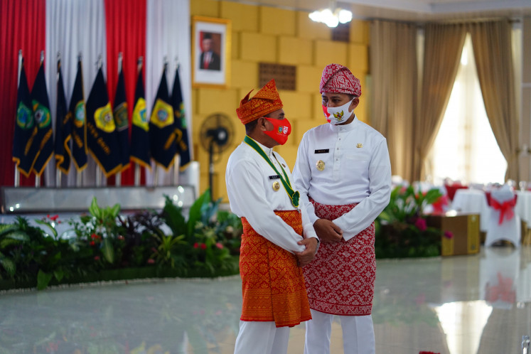 Then North Sumatra governor Edy Rahmayadi (left) and deputy governor Musa Rajekshah wear traditional cloths  at an event in Medan, North Sumatra, in August 2020.