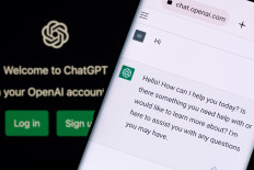 In this stock photo, ChatGPT chat bot screen is seen on smartphone and laptop display with Chat GPT login screen on the background.