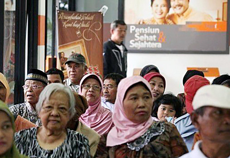 Cashing in: Retirees line up to cash their monthly pension fund in Jakarta on Feb. 15, 2011. 

