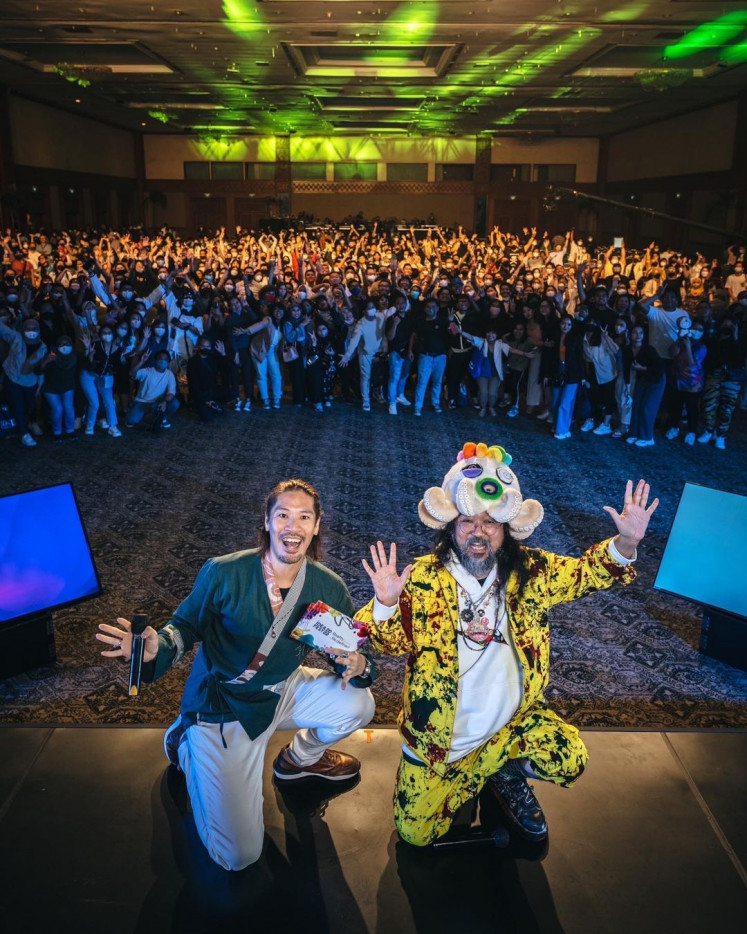 Influential: Japanese artist Takashi Murakami (right) poses with singer Hiroaki Kato and the sea of audience behind them who eagerly listens to Murakami's hour-long talk. (Instagram/Courtesy of Takashi Murakami)