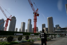 A man walks past the Central Business District (CBD) in Beijing on Jan. 17, 2023.
