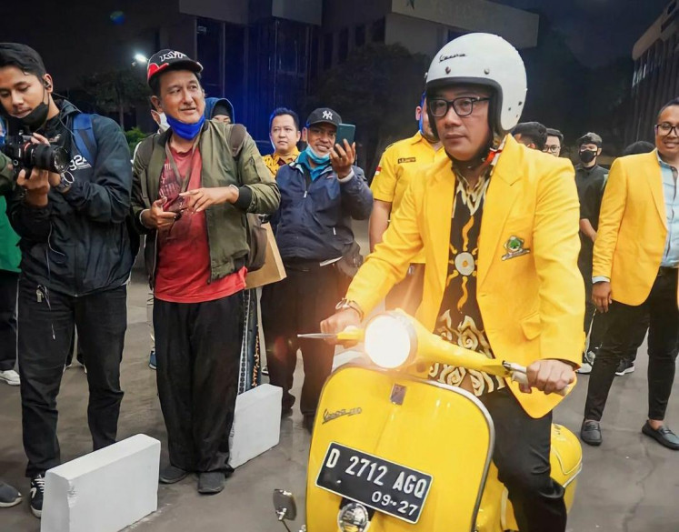 Amber alert: Donning the Golkar Party's yellow jacket, former West Java governor Ridwan Kamil (right) drives a matching yellow scooter outside Golkar's central executive office in Jakarta on Jan. 18, 2023. Recent polls suggest Ridwan could do well in either the West Java or Jakarta gubernatorial elections.