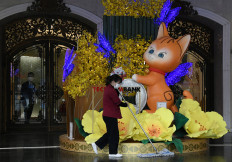 This photograph taken on January 16, 2023 shows a Vietnamese woman cleaning the front of a cat statue in a shopping mall in Hanoi, ahead of the Lunar New Year. 