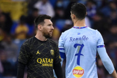 Paris Saint-Germain's Argentine forward Lionel Messi (left) walks past Riyadh All-Star's Portuguese forward Cristiano Ronaldo (right) during the Riyadh Season Cup football match between the Riyadh All-Stars and Paris Saint-Germain at the King Fahd Stadium in Riyadh on January 19, 2023. 

