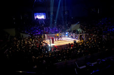 This photo is taken on December 20, 2015 shows Lethwei martial arts fighter Tun Tun Min in the ring with his opponent, US national Cyrus “Black Dynamite“ Washington, at the Thein Phyu boxing stadium in Yangon. 