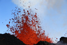 In this image released by the US Geological Survey, molten bombs are thrown into the air by the lava fountains at fissure 3 on the Northeast Rift Zone of Mauna Loa, Hawaii, on December 2, 2022. Fountains of lava and rivers of molten rock were spewing from the world's biggest volcano, as the first eruption there in almost four decades showed no signs of abating. 
