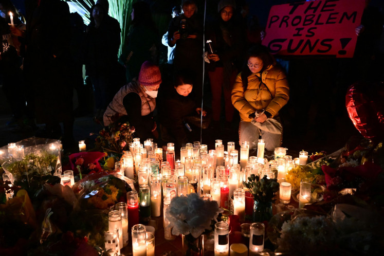 People take part in a candlelight vigil at Monterey Park City Hall on Jan. 24, 2023, three days after 11 people were gunned down in a mass shooting at the Star Ballroom Dance Studio in the Asian-majority city near Los Angeles, California.
