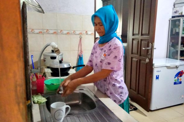 Daily routine: A domestic worker performs her daily chores on July 10, 2019, in Jakarta.