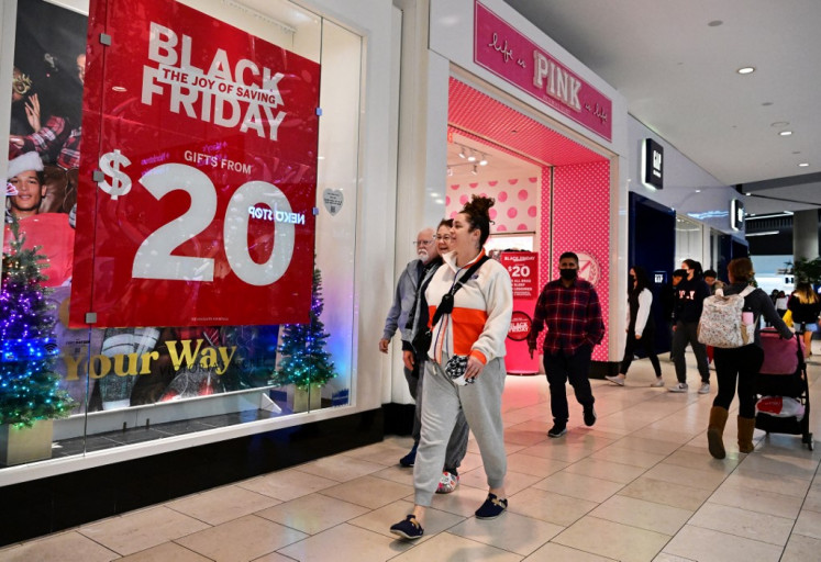 People shop during Black Friday in Santa Anita within the city of Arcadia, California, US, on Nov. 25, 2022. The US economy grew at a slower pace in 2022, the Commerce Department said on Jan. 26, 2023, as activity eased in the final months of the year and recession fears loomed.