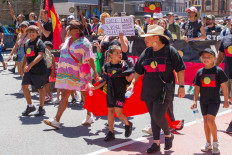 Participants wearing T-shirts with the image of the Aboriginal flag take part in the annual “Invasion Day” protest march through the streets of Sydney, Australia, on Australia Day on Thursday.