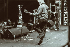 Masking the charm: Arno (left) and Delpi on stage during Dongker's performance at Urbanized Fest, Surabaya, East Java, on Dec. 3. (Adi Epicfar)